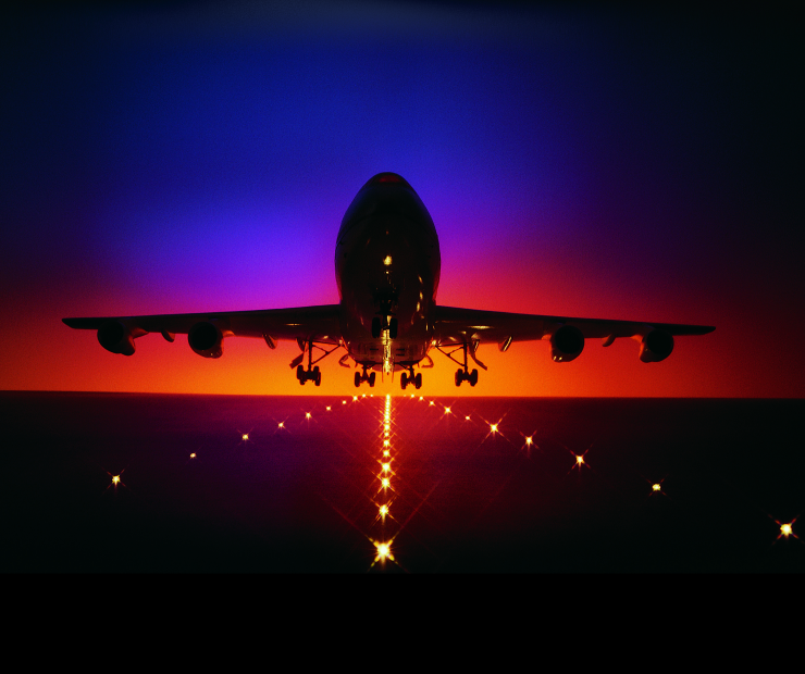 Plane lifting off from runway at dusk